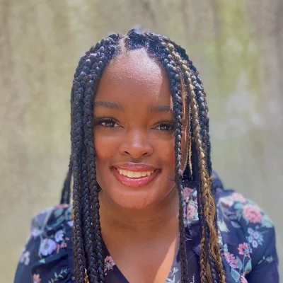 Public Relations Coordinator La’Nissa Smiling Outdoors